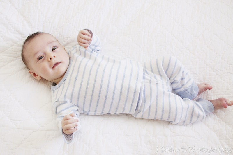 Baby lying on bed - baby portrait photography sydney